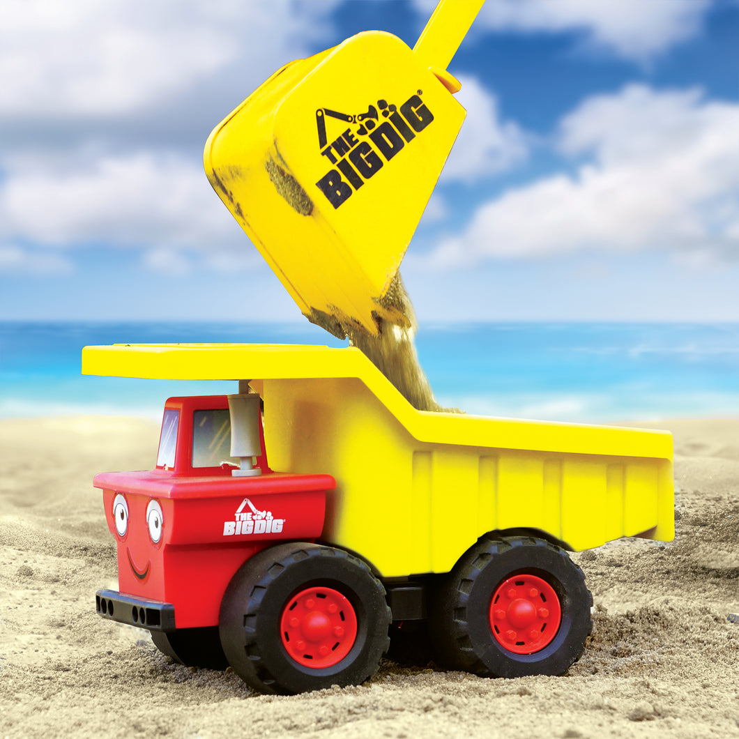 Big Dig Dump Truck on the beach with sand being dropped in by The Big Dig Bucket