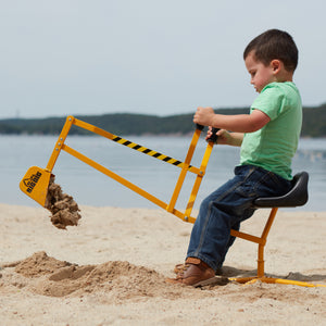 Boy on a Big Dig dumping sand at the Beach