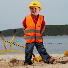 Load image into Gallery viewer, Boy at the Beach wearing The Big Dig Helmet and Vest